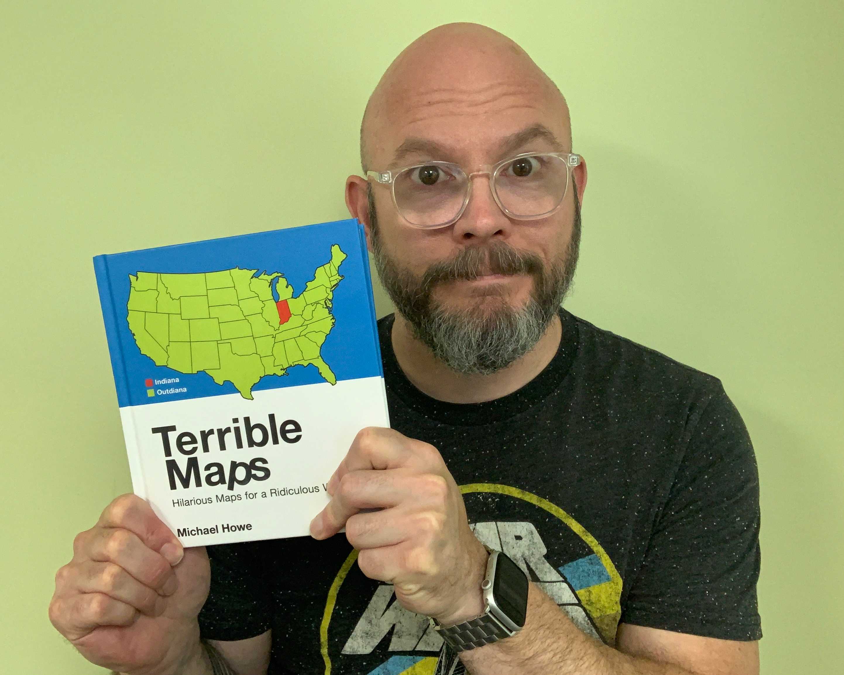 josemonkey holding a copy of Terrible Maps by Michael Howe